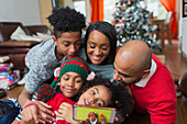 Happy family taking Christmas selfie