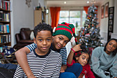 Portrait brothers hugging in Christmas living room