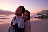 Portrait couple hugging on beach