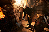 Female blacksmith working in workshop