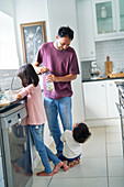 Family doing dishes in kitchen