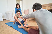 Happy family exercising in living room