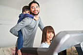 Portrait happy father and kids on treadmill
