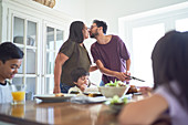 Affectionate couple kissing at dinner table