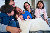 Happy family laughing on sofa