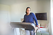 Smiling woman exercising on treadmill