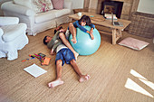 Playful father and kids with fitness ball