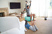 Father exercising with dumbbells with kids