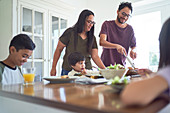 Family eating lunch at dining table