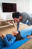 Playful father and daughter exercising