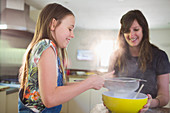 Happy mother and daughter baking