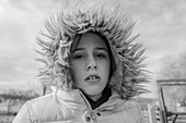 Portrait serious girl in fur hood jacket