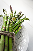Close up bundled fresh green asparagus