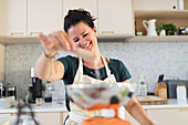 Smiling woman using baking scale