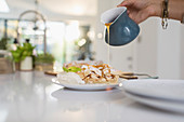 Woman pouring caramel sauce over pie