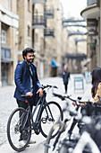 Businessman with bicycle on city street