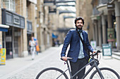 Businessman with bicycle in city street