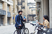 Business people with bicycles talking