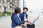 Business people with laptop working on boardwalk