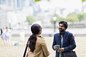 Business people talking in city park