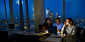 Business people working late at laptop