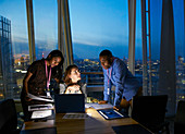 Business people working late at laptop