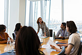 Businesswoman leading conference room meeting