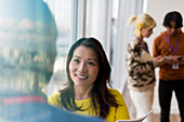 Businesswoman talking with colleague in office