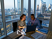 Business people working at laptop, London, UK
