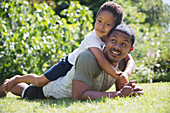 Portrait affectionate father and son laying