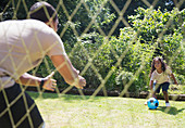 Father and daughter playing soccer