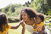 Daughter feeding watermelon to happy mother