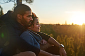Couple relaxing in nature at sunset