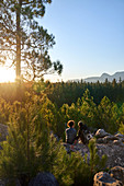 Young hiker couple enjoying view of trees