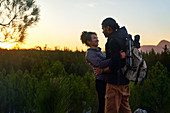 Hiking couple in nature at sunset