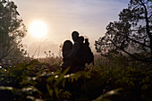 Silhouette serene couple enjoying sunset in nature