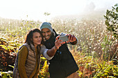 Couple taking selfie in tall grass