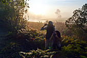 Curious couple hiking with binoculars