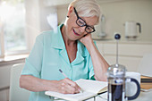 Senior woman writing in journal