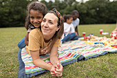 Mother and daughter relaxing in park