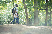 Father and daughter holding hands hiking