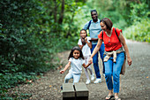 Happy family walking on trail in woods