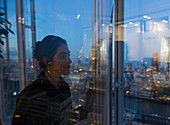 Business woman at highrise office window