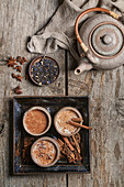 Masala chai served in ceramic bowls with star anise and cinnamon sticks