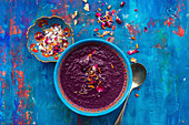 Roasted purple carrot and lentil soup topped with seasalt and edible petals