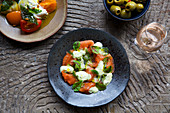 Salmon and pastrami salad with tomatoes and olives