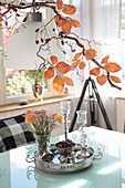 Spring bouquet of ranunculus below artistically arranged autumn twigs