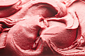 Creamy raspberry icing sugar (close-up, full-frame)
