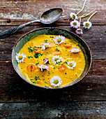 Carrot soup with daisies