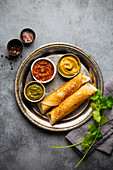 Traditional Indian rice pancakes Dosa with different dips chutney and seasonings